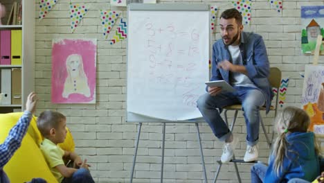 Young-Man-Teaching-Kids-in-Comfortable-Classroom