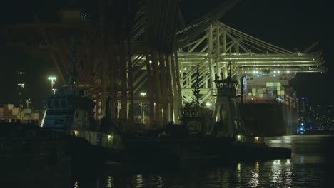 Port-of-Seattle-Shipping-Terminal-Duwamish-River-Tractor-Tugboats-Freighter-Ship-Unloading-Cargo-Containers-at-Night