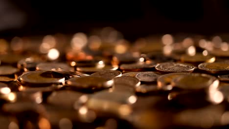 Close-up-money-the-coin-stacking-on--the-floor-in-dark-light-,-business-and-financial-for-money-saving-or-investment-background-concept--,-extremely-close-up-and-shallow-DOF