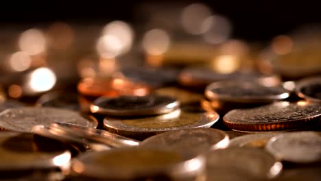 Close-up-money-the-coin-stacking-on--the-floor-in-dark-light-,-business-and-financial-for-money-saving-or-investment-background-concept--,-extremely-close-up-and-shallow-DOF