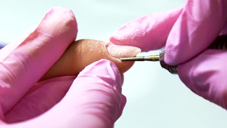 Beautician-careful-and-accurate-removing-cuticles-with-polish-machine