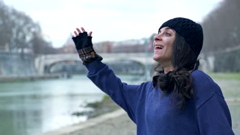 homeless-woman-walks-and-greets-smiling-at-someone