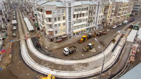 Asphalt-paver,-roller-and-truck-on-the-road-repair-site-during-asphalting-timelapse.-Road-construction-equipment