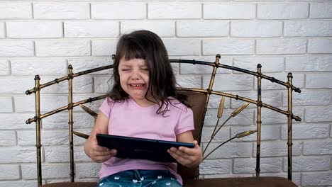 Sad-child-with-a-tablet.