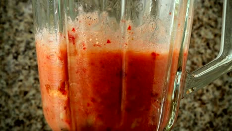 Preparation-of-cocktail-in-the-blender-from-apples,-bananas-and-strawberry.	Slow-motion.