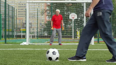 Three-Senior-Men-Playing-Football
