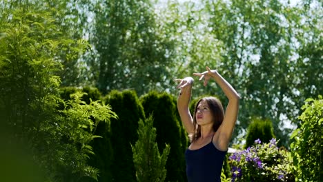 Pan-from-beautiful-female-dancer-up-to-sky,-slow-motion-summer-outdoor-garden