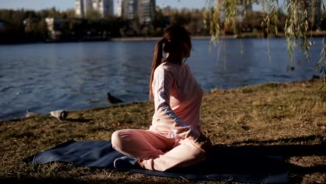 Girl-in-headphones-on-the-promenade-in-yoga.