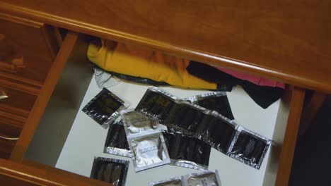 A-man-takes-a-condom-from-the-bedside-table.-Protection-against-aids-and-pregnancy.