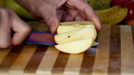 Man-is-slicing-apple-in-slow-motion