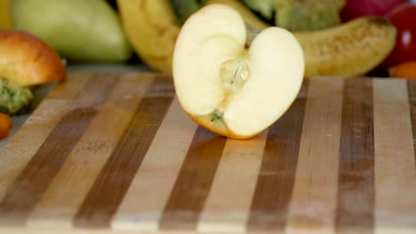 Apple-slices-fall-on-cutting-board-in-slow-motion