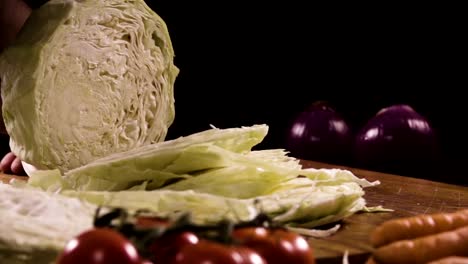 Cutting-cabbage-with-knife-on-the-wood.-Slow-motion-240-fps