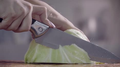 Cutting-cabbage-with-knife-on-the-wood.-Slow-motion