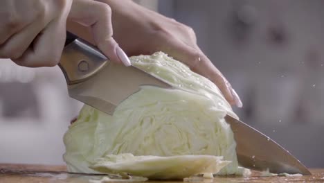 Cutting-cabbage-with-knife-on-the-wood.-Slow-motion