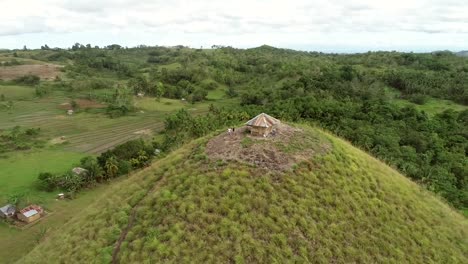 Aerial-view-couple-on-the-top-of-Chocolate-Hills-Complex,-Batuan,-Philippines.