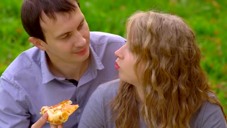 girl-biting-pizza-in-the-Park