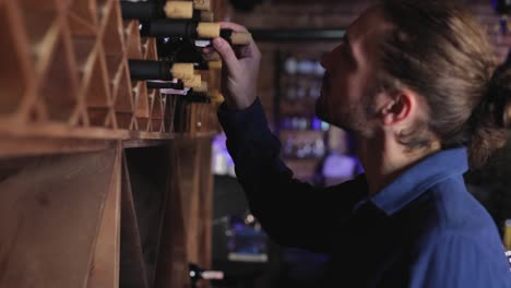 Wine-Restaurant.-Handsome-Man-Choosing-Wine-Bottle-On-Shelf