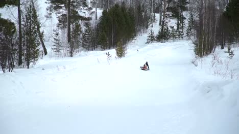 Woman-and-Little-Girl-Riding-on-a-Sledding-Tubing