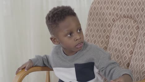 Portrait-of-funny-african-american-child-boy-chewing-gum