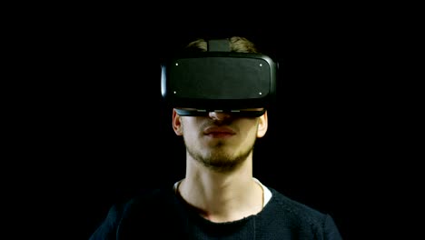 young-nice-man-using-3d-reality-in-life-with-oculus-and-augmented-reality-technology-with-implements-of-reality.