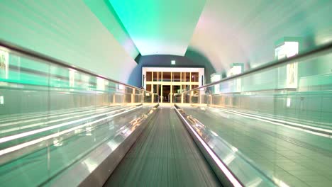 Illuminated,-empty,-multi-colored-moving-walkway