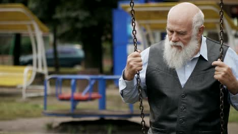 Depressive-senior-man-swings-on-seesaw-in-slowmotion