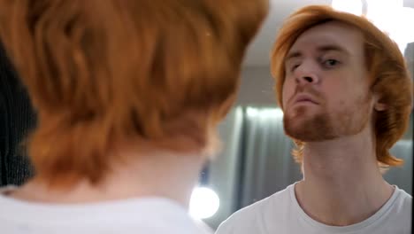 Redhead-Beard-Man-Checking-at-His-Teeth-in-Mirror