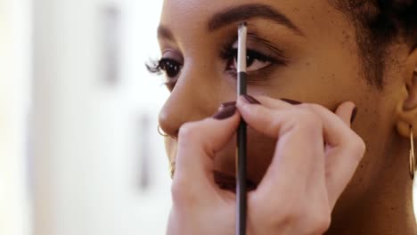 Process-eyebrow-shaping-in-fashionable-makeup-studio-close-up