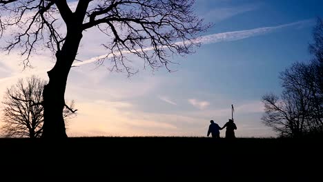 Grim-Reaper-came-for-a-new-victim-and-leads-the-victim-to-death.-sunset-silhouette.-concept-of-death