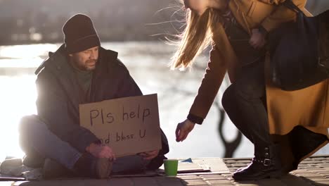 Passing-by-woman-spares-coins-to-homeless-man