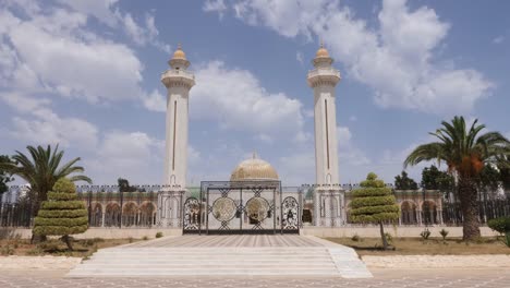 Gate-at-entrance-to-mausoleum-Habib-Bourguiba-with-golden-dome-in-Monastir-city.-Outdoors-dolly-shot