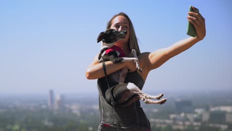 Junge-passen-Frau,-die-malerischen-Selfies-auf-ihr-Handy-mit-ihrem-Hund