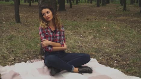 Sad-young-girl-is-sitting-in-the-forest