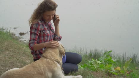 Pretty-woman-and-dog-is-resting-outdoor-together