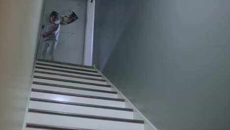 A-girl-runs-up-a-set-of-stairs-and-a-dog-runs-up-after-her