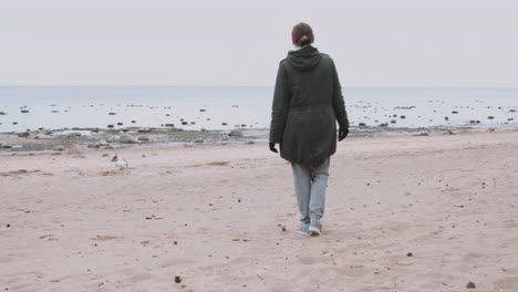 Woman-playing-with-dog-on-the-sea-shore