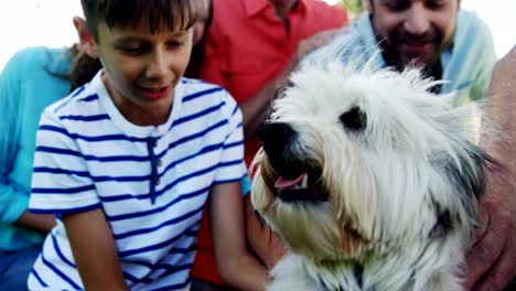 Multi-generation-family-playing-with-their-dog