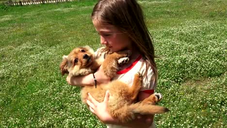 Child-Walks-Kissing-and-Hugging-her-Puppy,-Child-Playing-with-her-Little-Dog