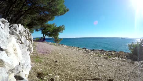 4K-footage-of-a-man-canicrossing-on-a-sunny-afternoon-along-the-Croatian-coast