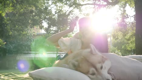 family-hugs-the-hound-close-up-in-backlight-on-background-of-nature