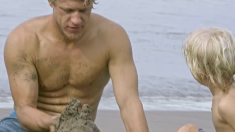 Dad-and-Little-Son-Building-Sandcastle-at-Ocean-Beach