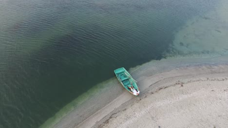 Man-with-a-dog-are-resting-in-small-boat