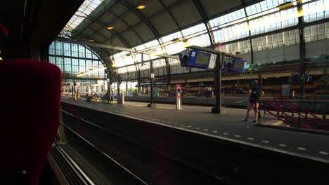 inside-the-moving-modern-train-leaving-the-platform-Amsterdam-Central-station-in-Europe