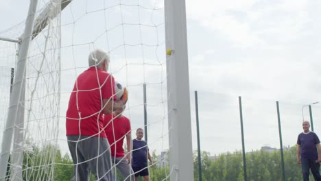 Pensioner-Catching-Football-at-Goal-Net