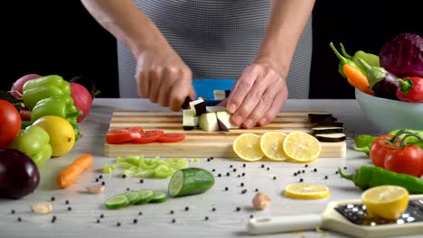 Chef-is-cutting-eggplant-in-the-kitchen