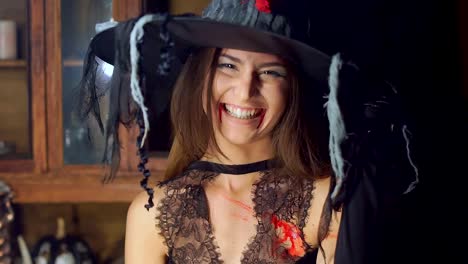 Halloween-witch-raises-her-head-from-under-the-hat-angrily-laughing