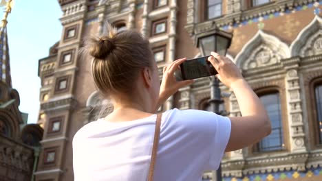 Woman-taking-pictures-of-Church-of-the-Savior-on-Blood-with-smartphone.