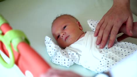 Parents-Petting-Newborn-Baby-in-Crib