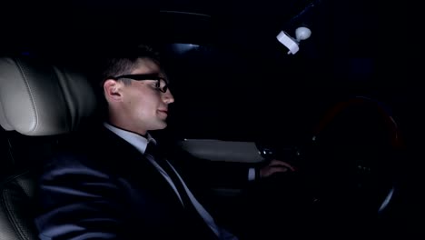 Angry-businessman-furiously-hitting-steering-wheel-in-car-at-nighttime,-problems