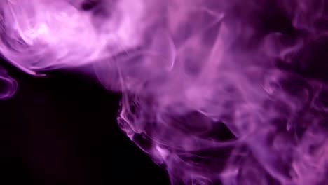 Purple-Steam-Rises-from-up.-Blue-smoke-over-a-black-background.-Smoke-slowly-floating-through-space-against-black-background.-Slow-Motion.